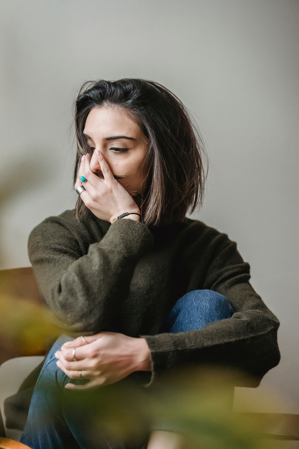 Depressed woman sitting in room